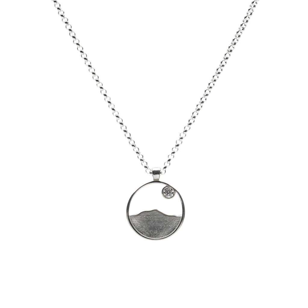 Gemstone-accented Camel’s Hump pendant in sterling silver or 14K gold on an 18-inch chain.