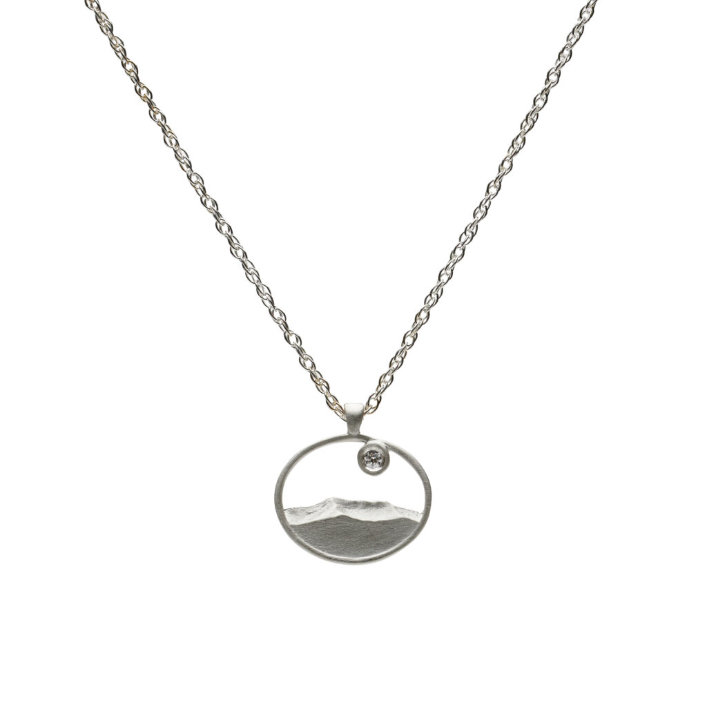 Mount Mansfield Ridgeline Glow pendant in sterling silver or 14K gold with a flush-set gem on an 18-inch chain.