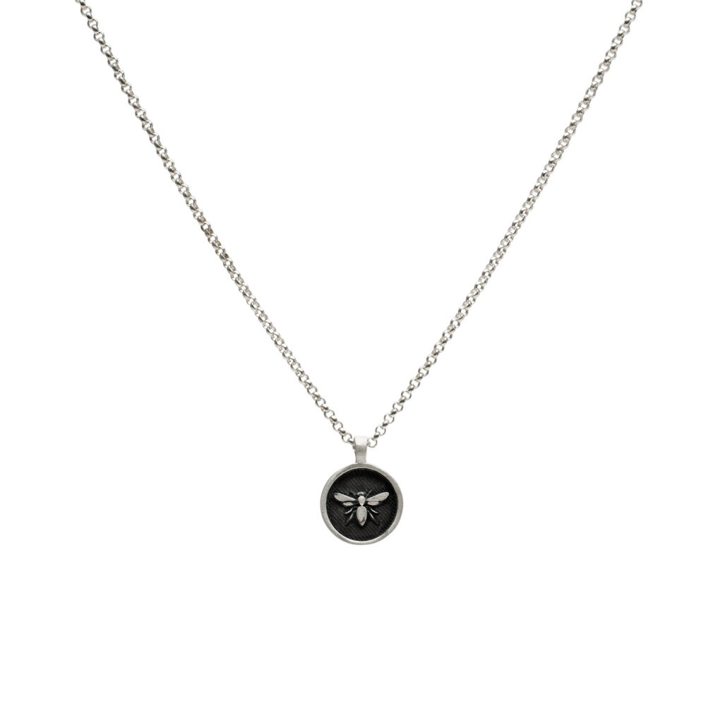 Oxidized sterling silver bee pendant with raised details on an 18-inch chain.