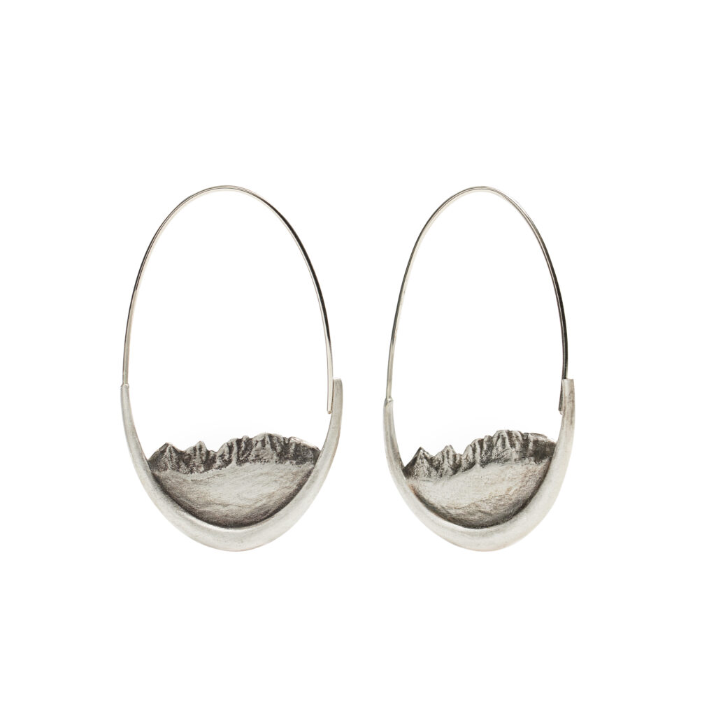 Oxidized sterling silver or 14K gold hoop earrings shaped like mountain ridgelines, capturing natural landscapes and adventure.