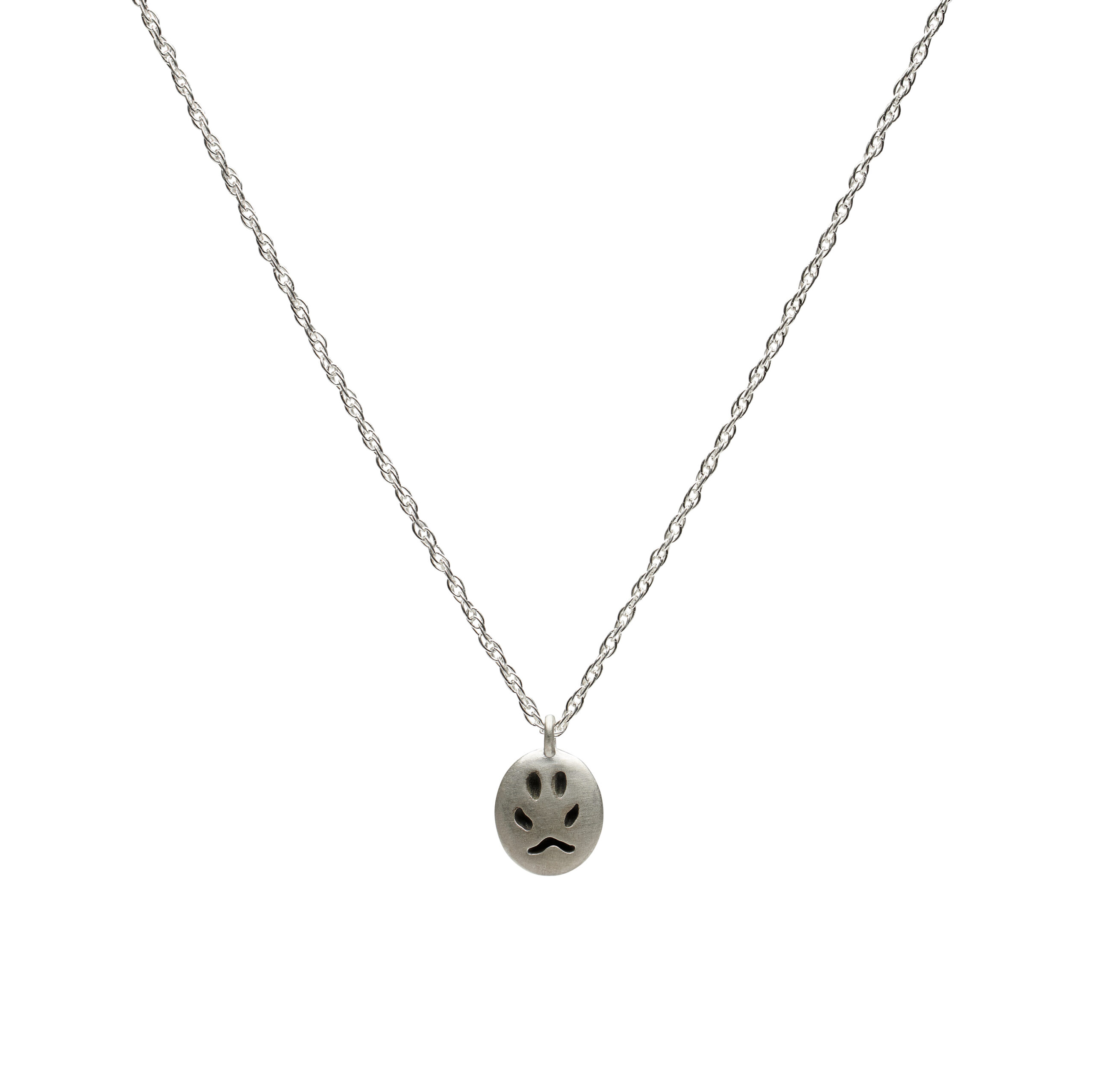 Silver pendant depicting a fox paw print