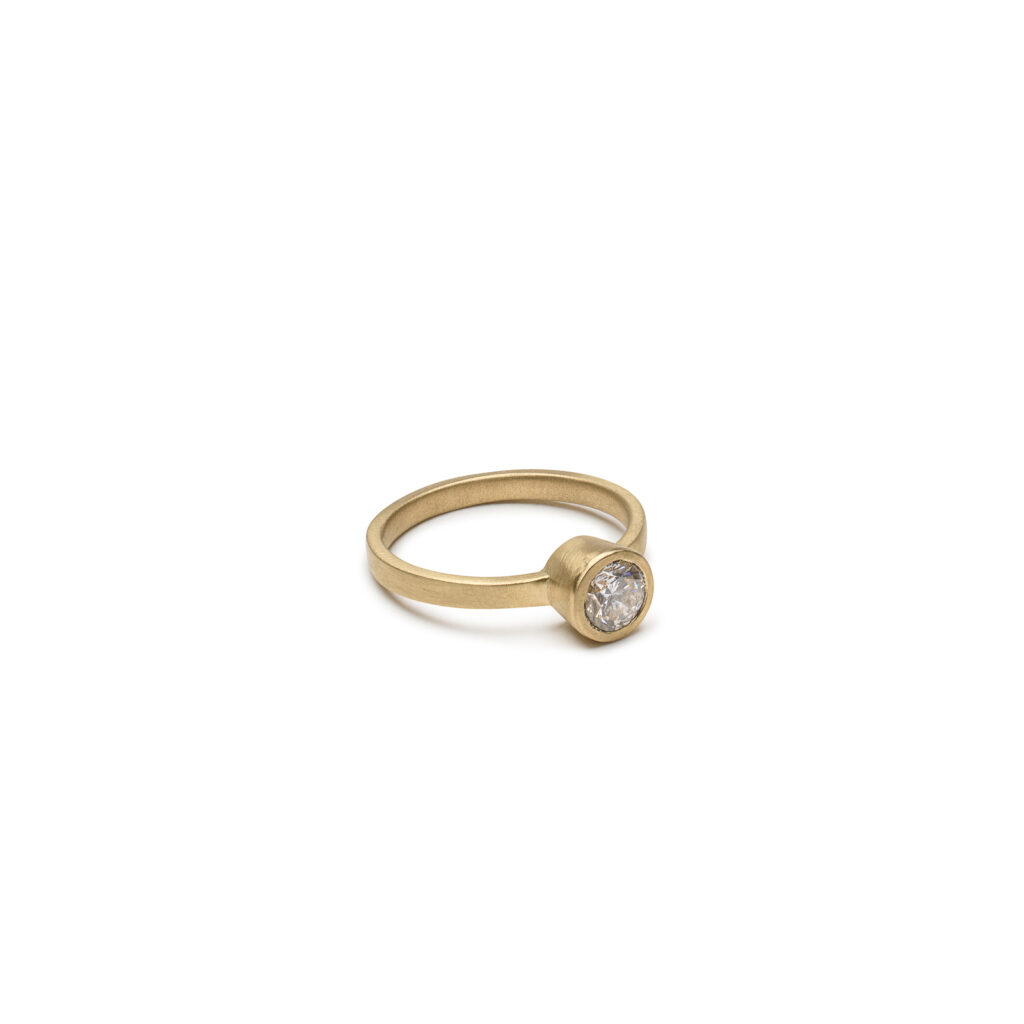 Modern bezel-set diamond engagement ring with square band