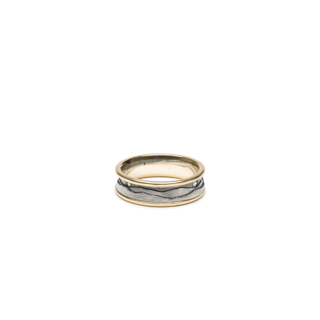 Green mountain ring with flush set diamonds