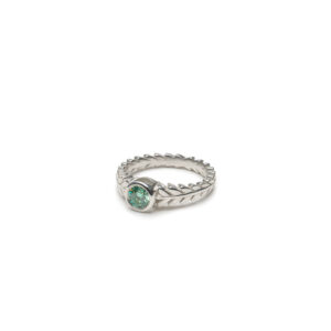 Aurora ring with a bezel-set .45ct teal moissanite, inspired by forest light, available in silver, gold, or platinum.