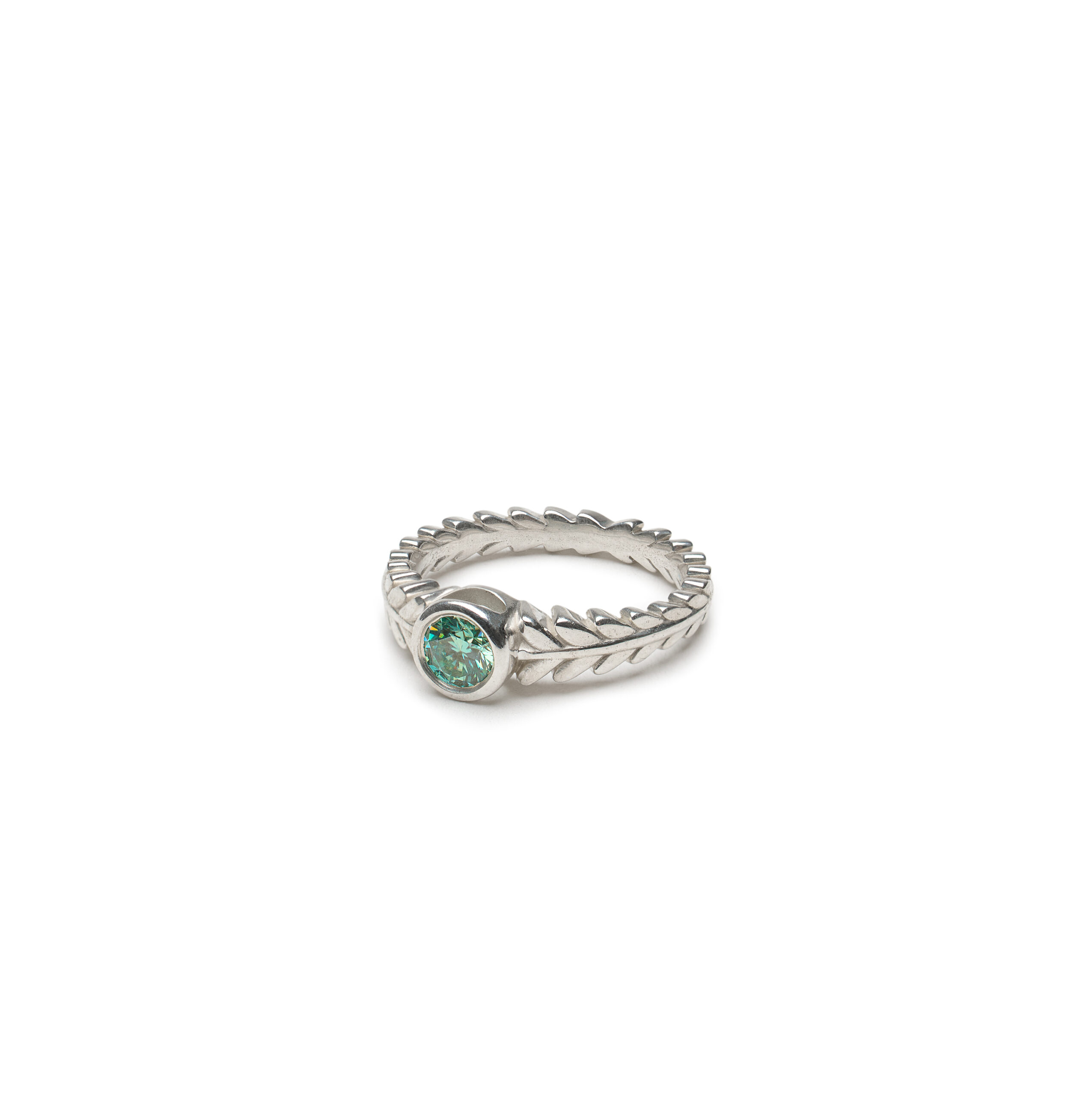 Aurora ring with a bezel-set .45ct teal moissanite, inspired by forest light, available in silver, gold, or platinum.