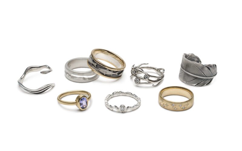 A collection of rings in gold and silver with forest inspired inspiration
